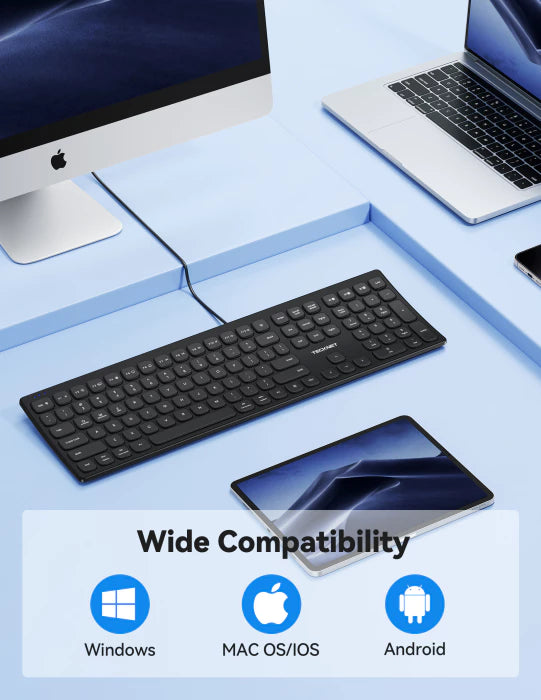 Black keyboard on a light blue surface with computer monitor, laptop, and smartphone, featuring compatibility icons for Windows, Mac OS/iOS, and Android.